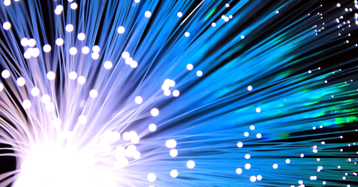 Blue and white fiber-optic strands glowing against a black background.